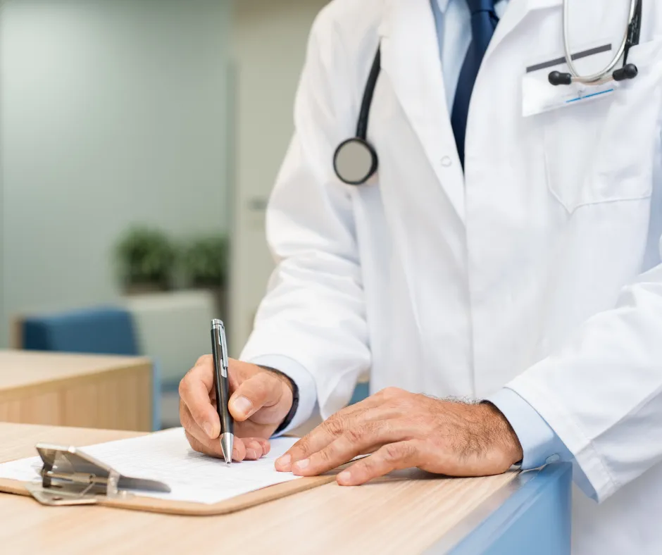 Doctor taking notes with a patient during COGNISION System cognitive testing