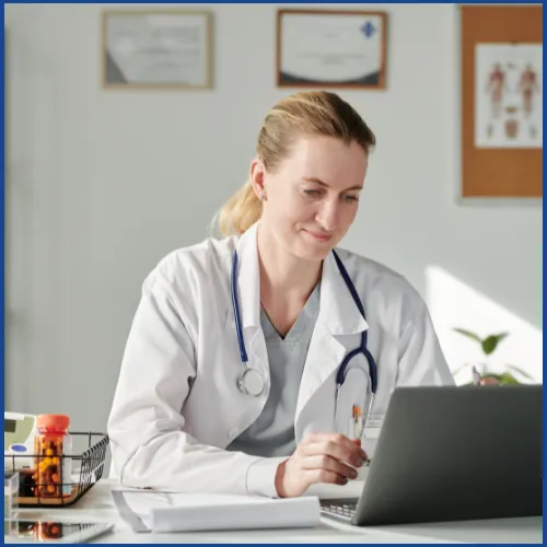 Doctor at her computer reviewing COGNISION System results