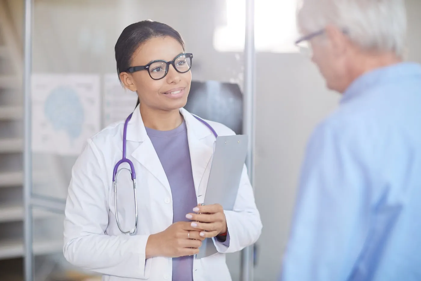 Female doctor with senior patient at hospital - VAT ENG TEST