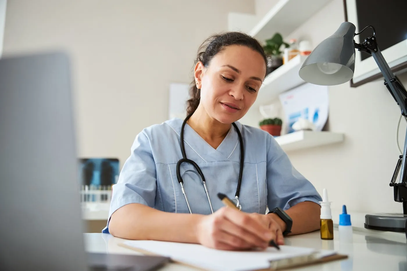 Female doctor taking notes after VAT ENG test