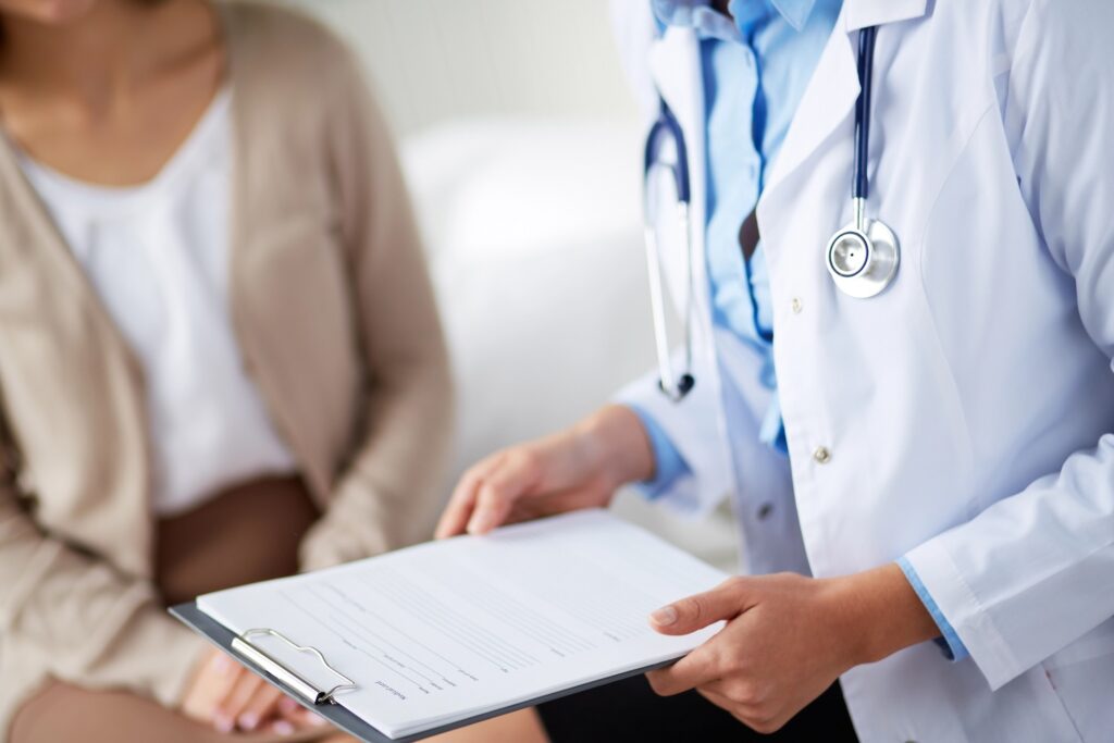 Doctor handing paperwork to patient