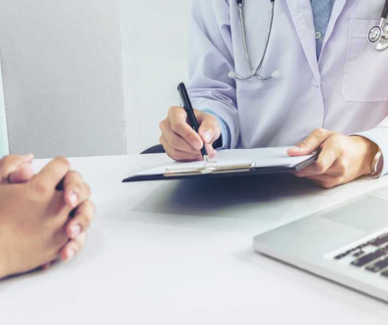 Doctor taking notes during patient evaluation