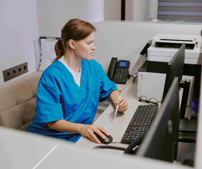 Nurse checking patient file on computer