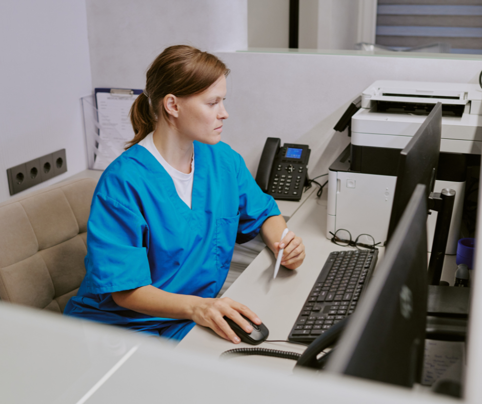 Nurse checking patient file on computer